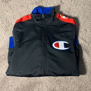 Size s in men’s. Blue,Red,White, and Black Champion jacket.